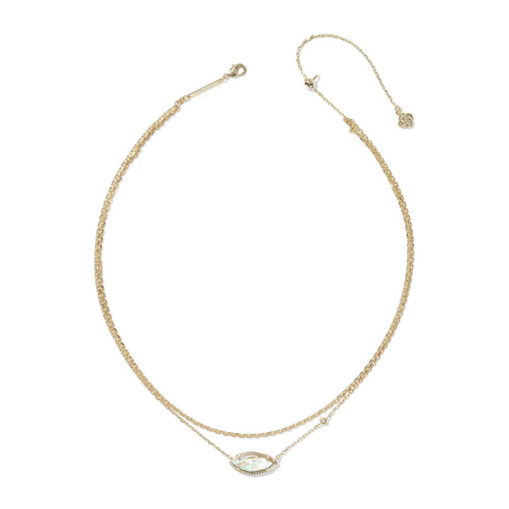 Gold necklace with a pink gemstone on a white background