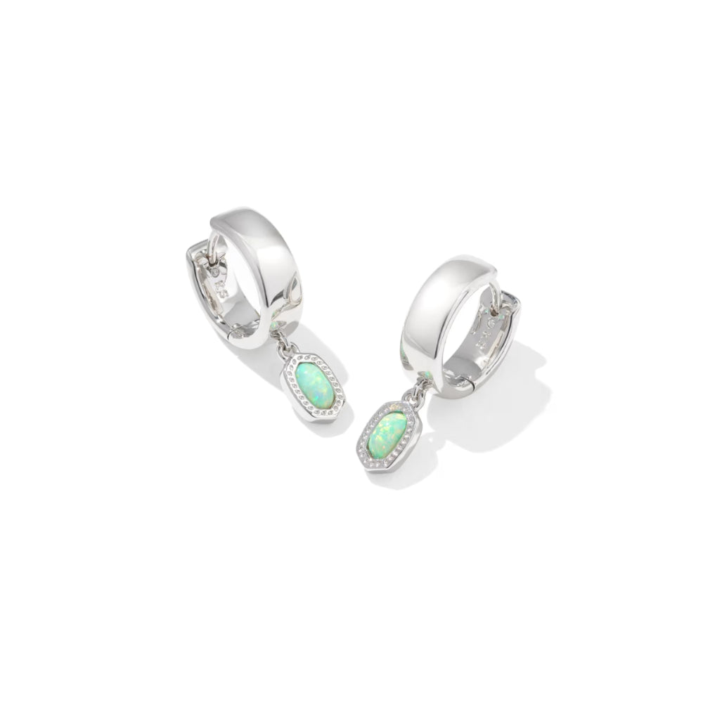 Silver hoop earrings with green gemstones on a white background