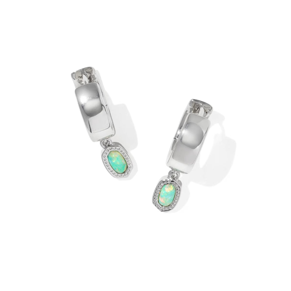 Pair of silver hoop earrings with green gemstones on a white background