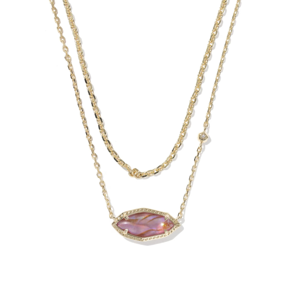 Gold necklace with a pink gemstone pendant on a white background