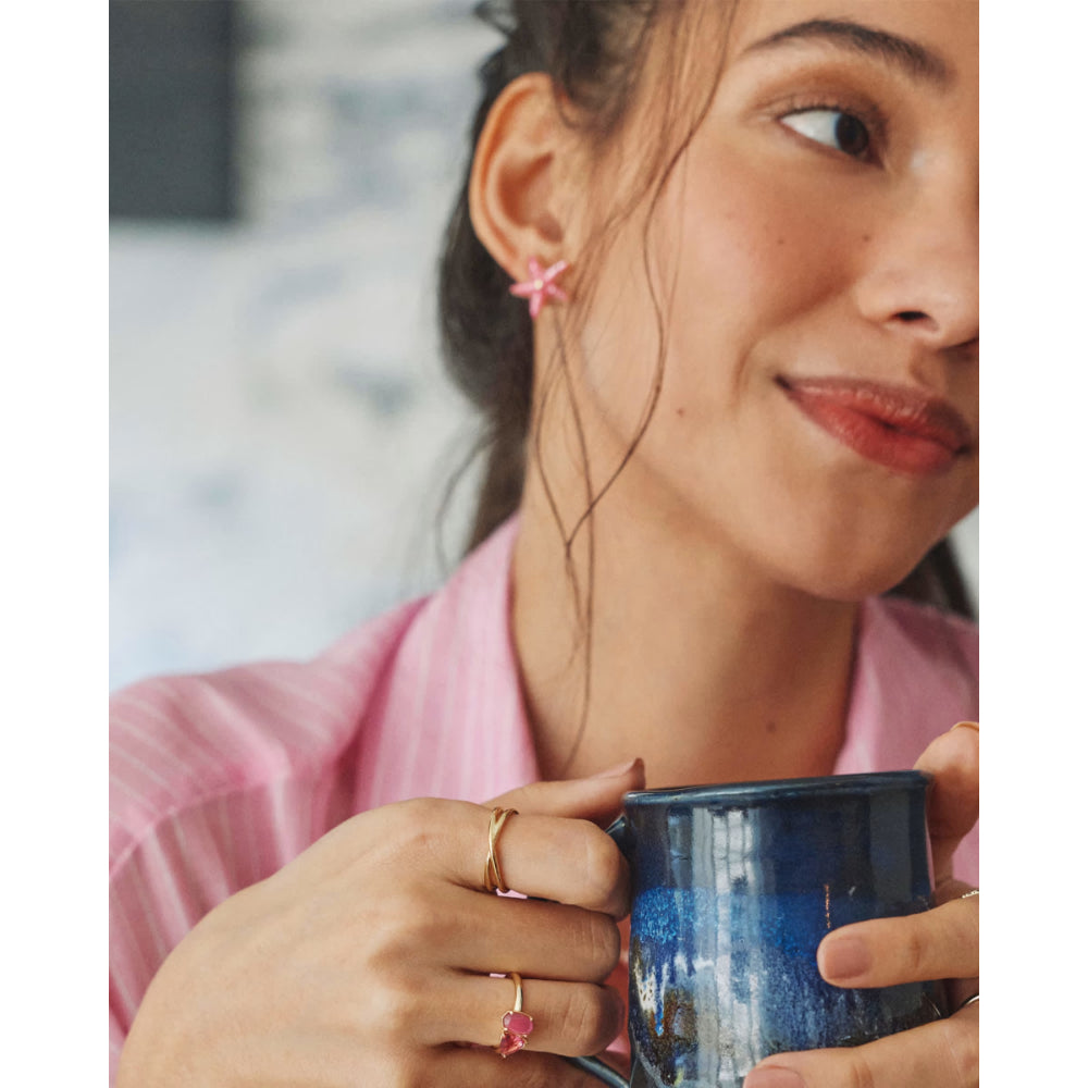 Woman holding a blue mug with a blurred background