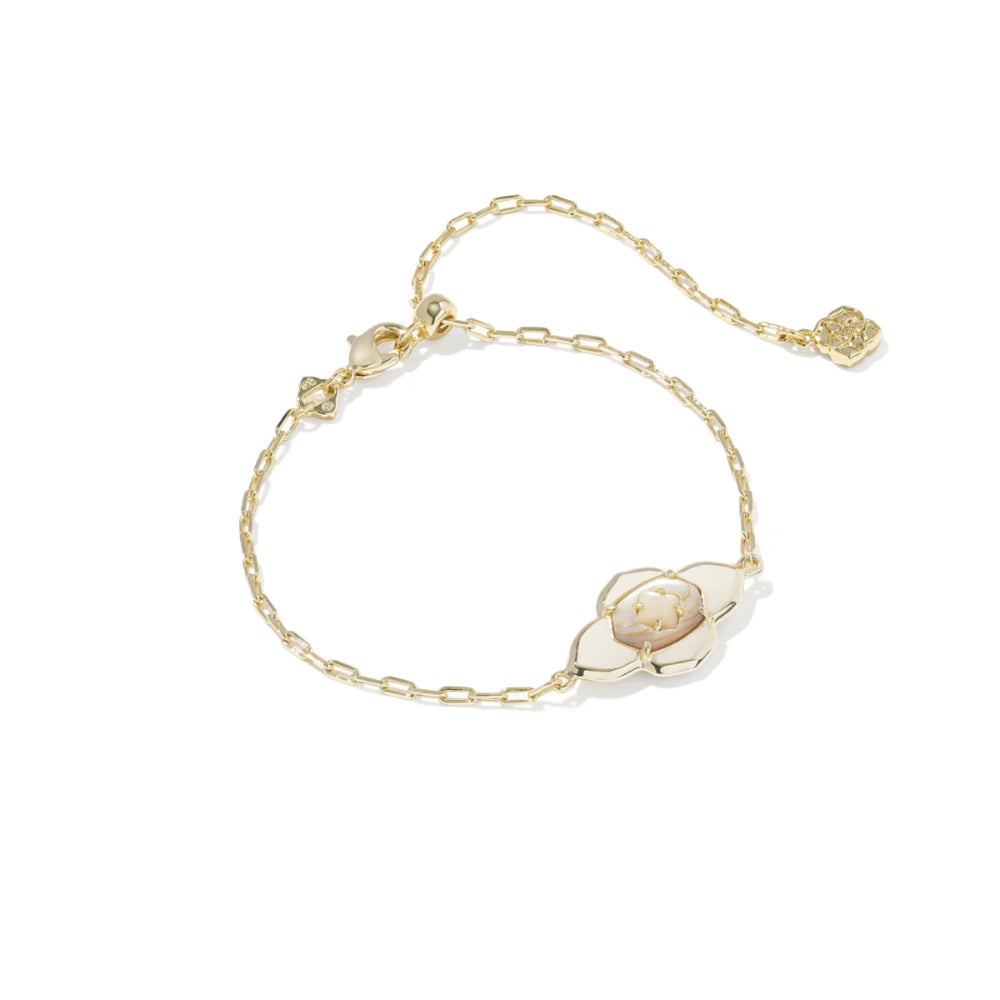 Gold bracelet with a floral design on a white background