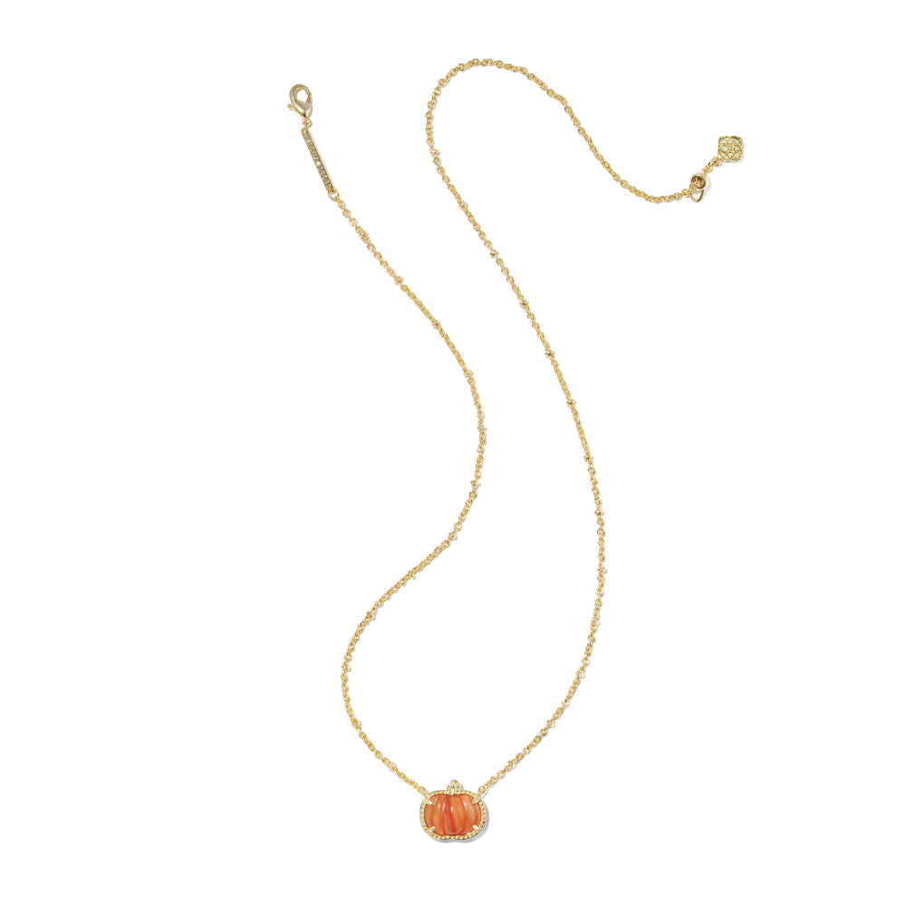 A delicate gold chain necklace featuring a small orange pumpkin pendant with a halo of tiny clear stones, displayed on a clean white background.