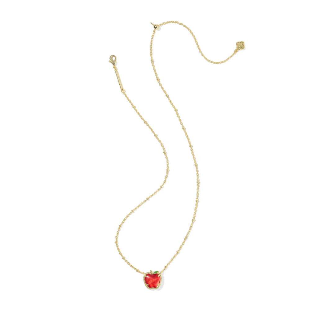 A delicate gold chain necklace featuring a small, heart-shaped red gemstone pendant, displayed on a clean white background.