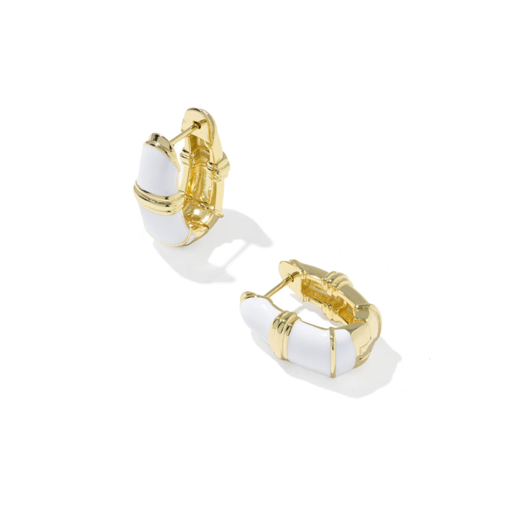 A pair of gold hoop earrings with white curved enamel inlays, shown on a clean white background with soft shadows.