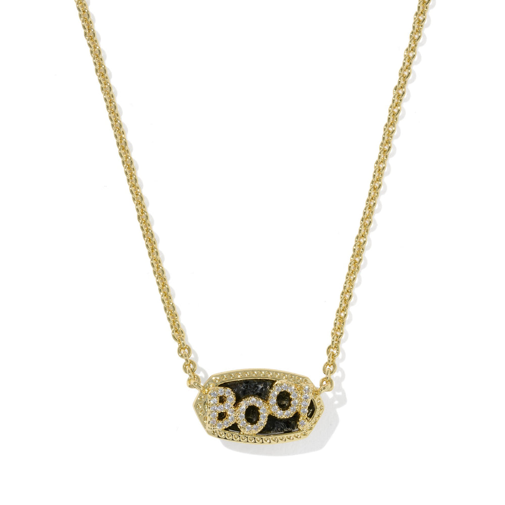 A gold chain necklace with a pendant spelling 'BOO' in raised gold letters, set against a black background and decorated with small clear stones.