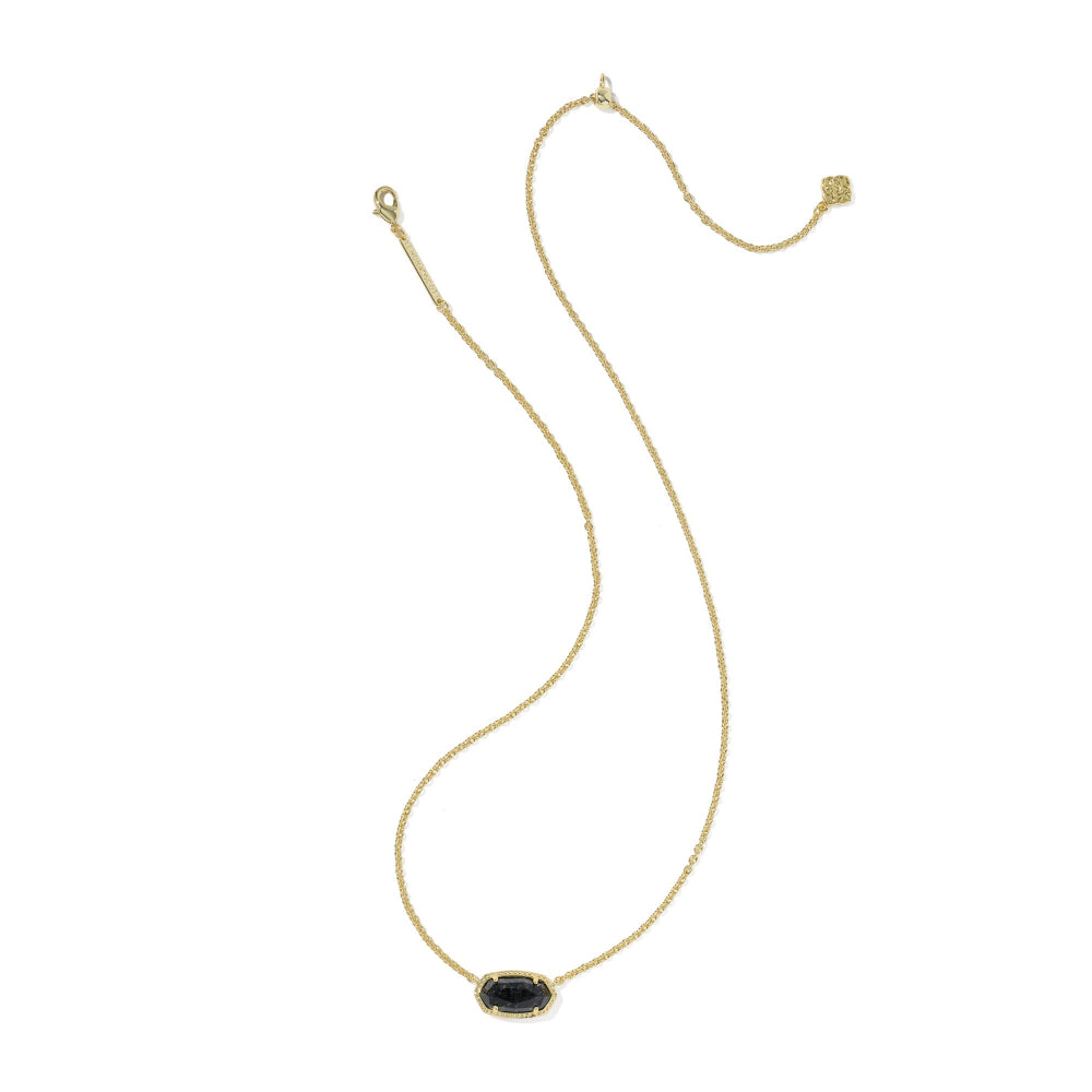 A delicate gold chain necklace featuring an oval black enamel pendant with a gold border, displayed on a clean white background.