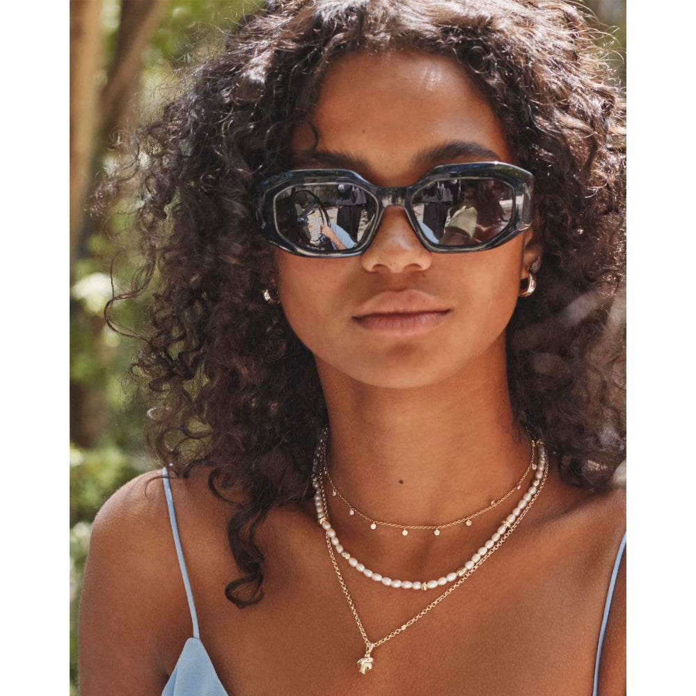 Woman wearing sunglasses with a blurred natural background