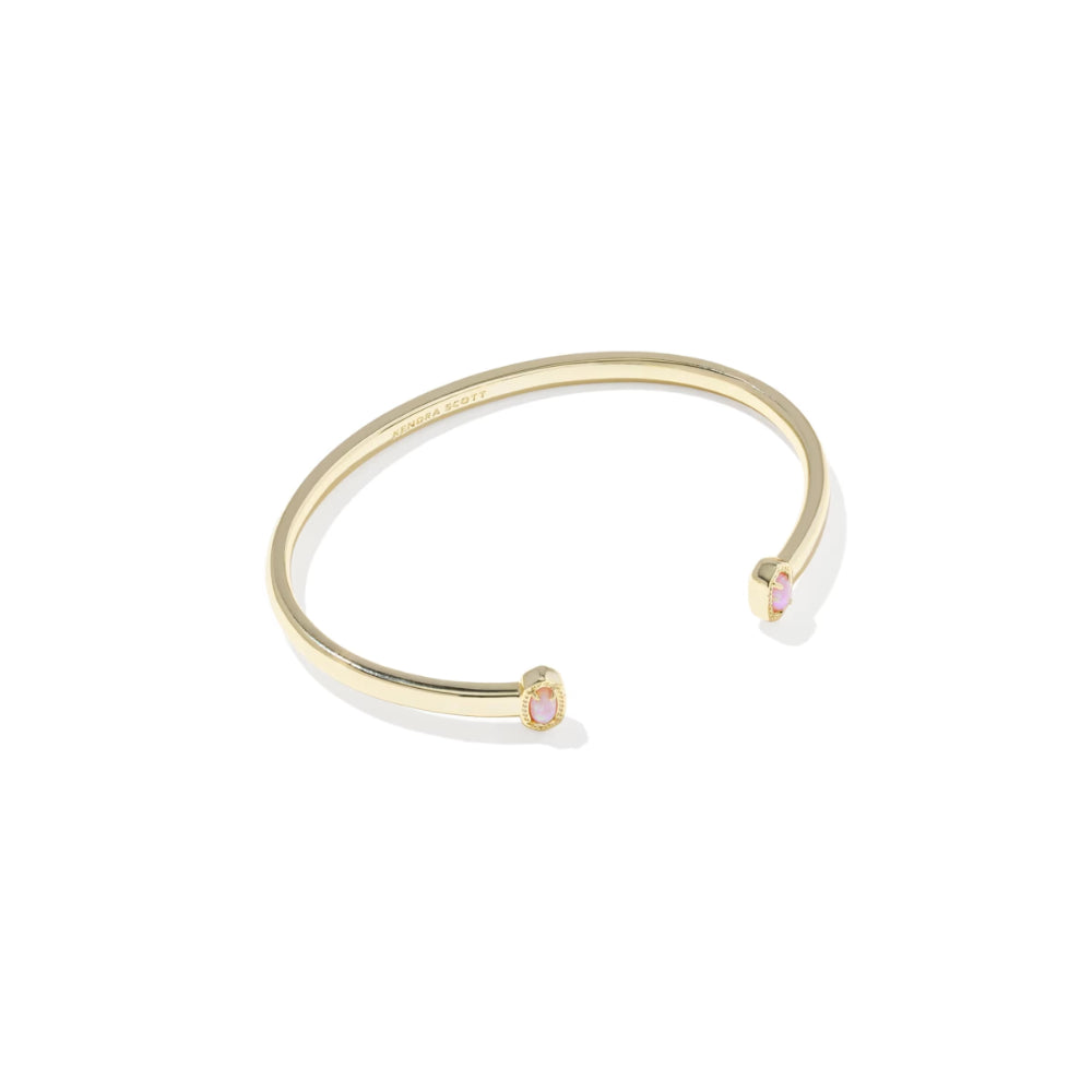 Gold bracelet with pink gemstones on a white background