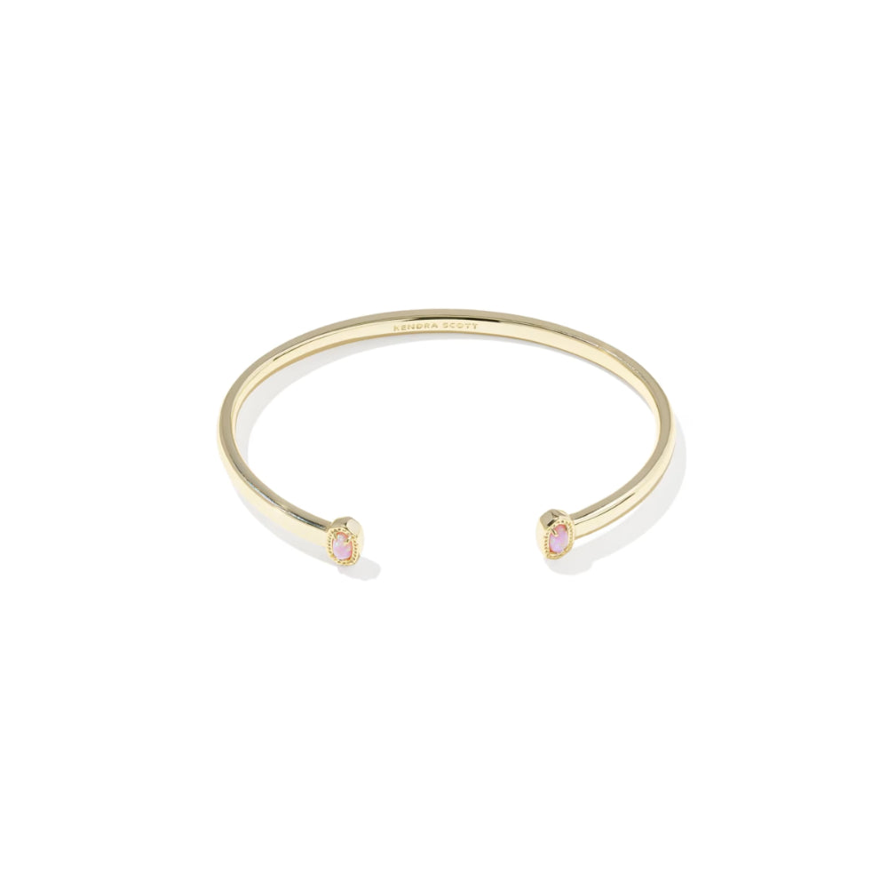 Gold bracelet with pink gemstones on a white background