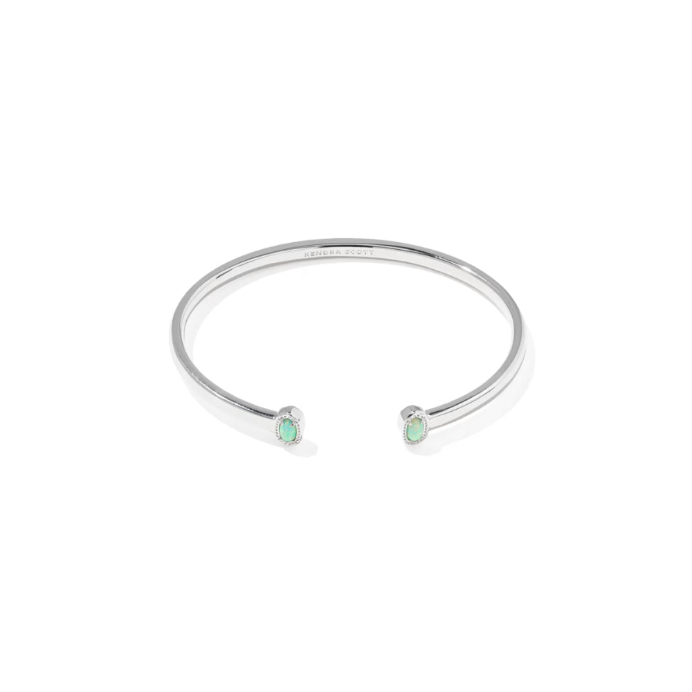 Silver bracelet with two green gemstones on a white background