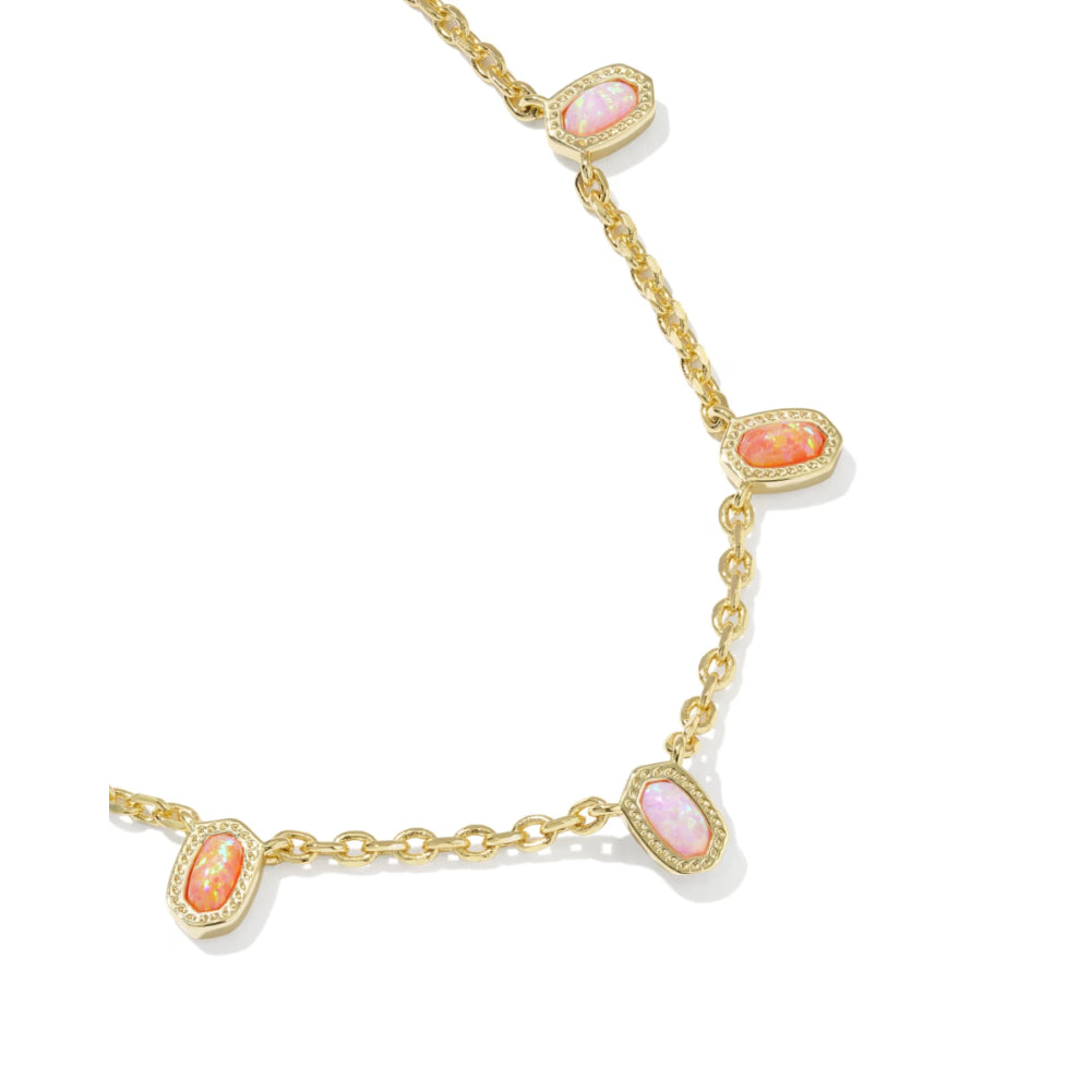 Gold necklace with pink gemstones on a white background