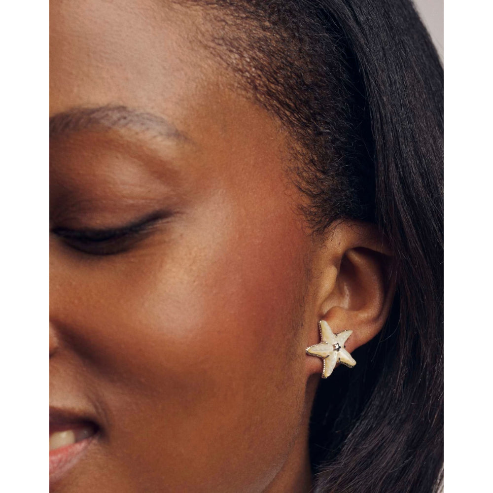 Close-up of a woman wearing a star-shaped earring.