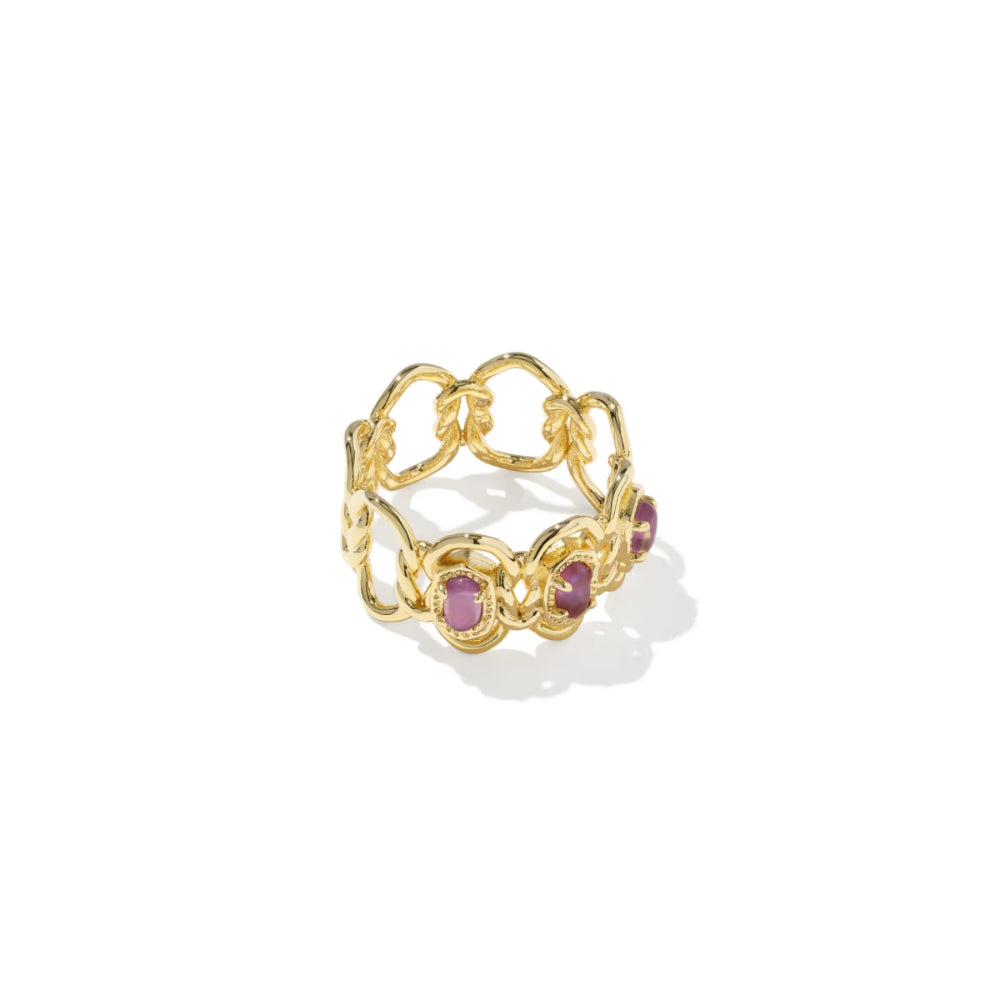 Gold ring with purple gemstones on a white background