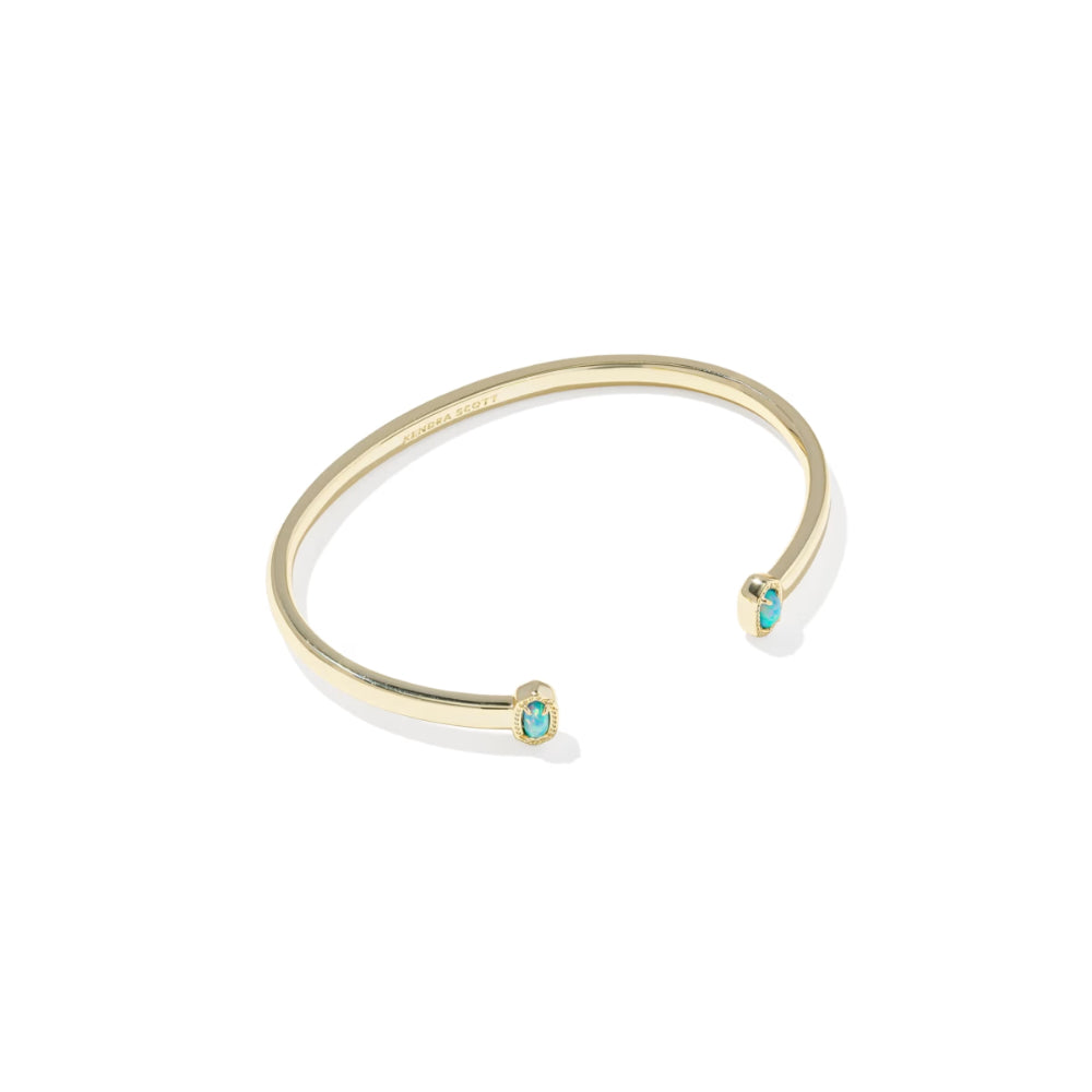 Gold bracelet with turquoise stones on a white background