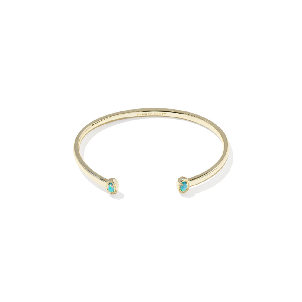 Gold bracelet with turquoise stones on a white background