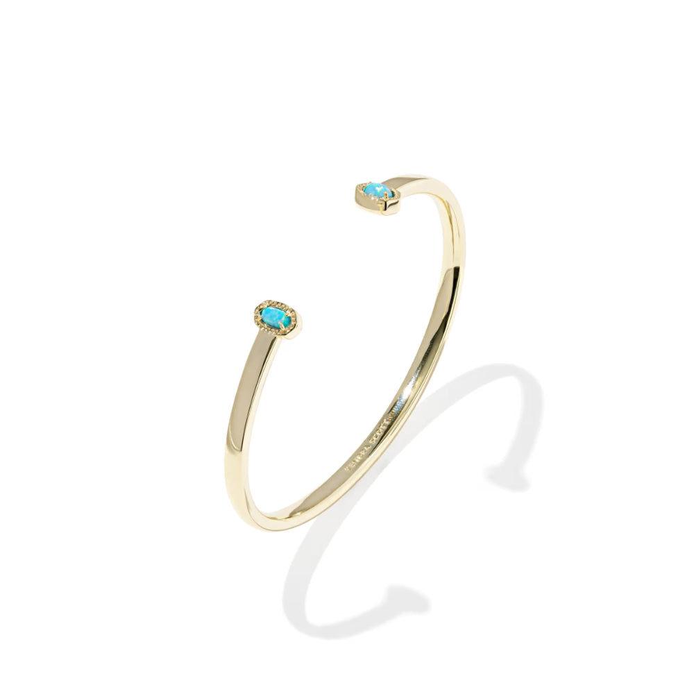 Gold bracelet with turquoise stones on a white background