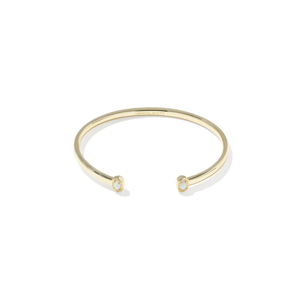Gold bracelet with small gemstones on a white background