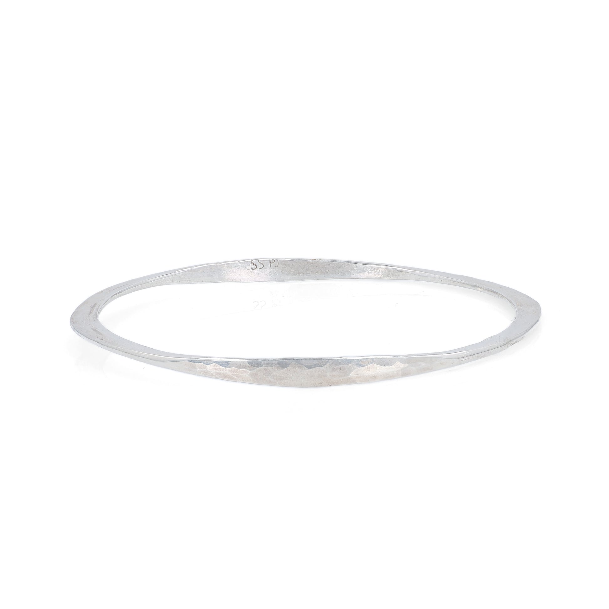 Silver hammered bangle bracelet on a white background