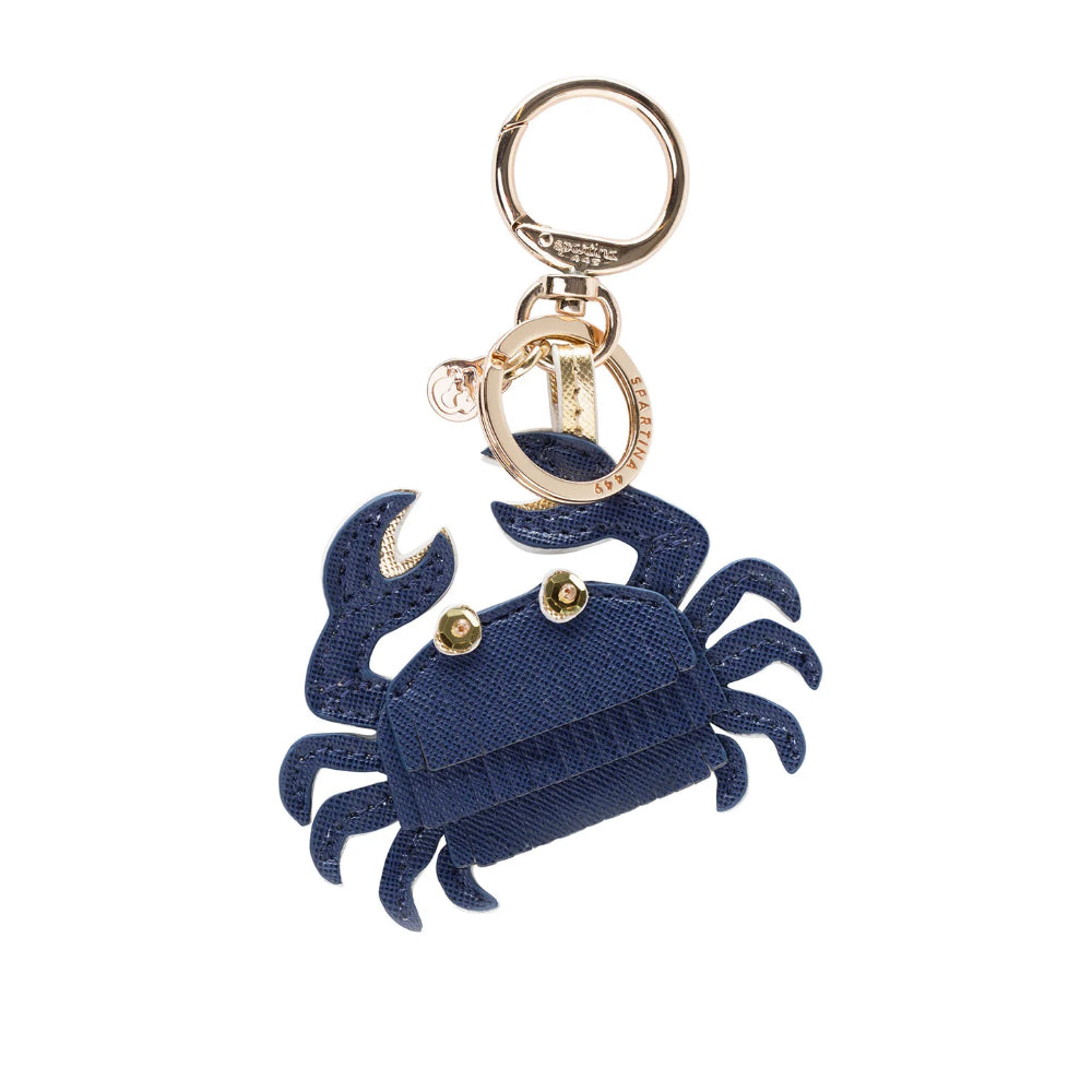 A navy blue textured fabric crab keychain with gold-tone metal hardware, including a split key ring, lobster clasp, and small decorative gold accents.
