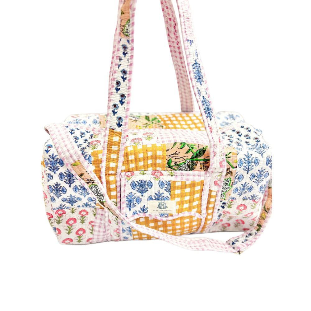 Multicolored patterned bag with a strap on a white background