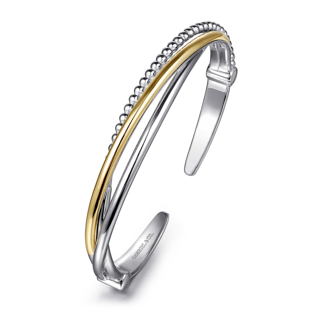 Two-toned silver and gold bracelet on a white background