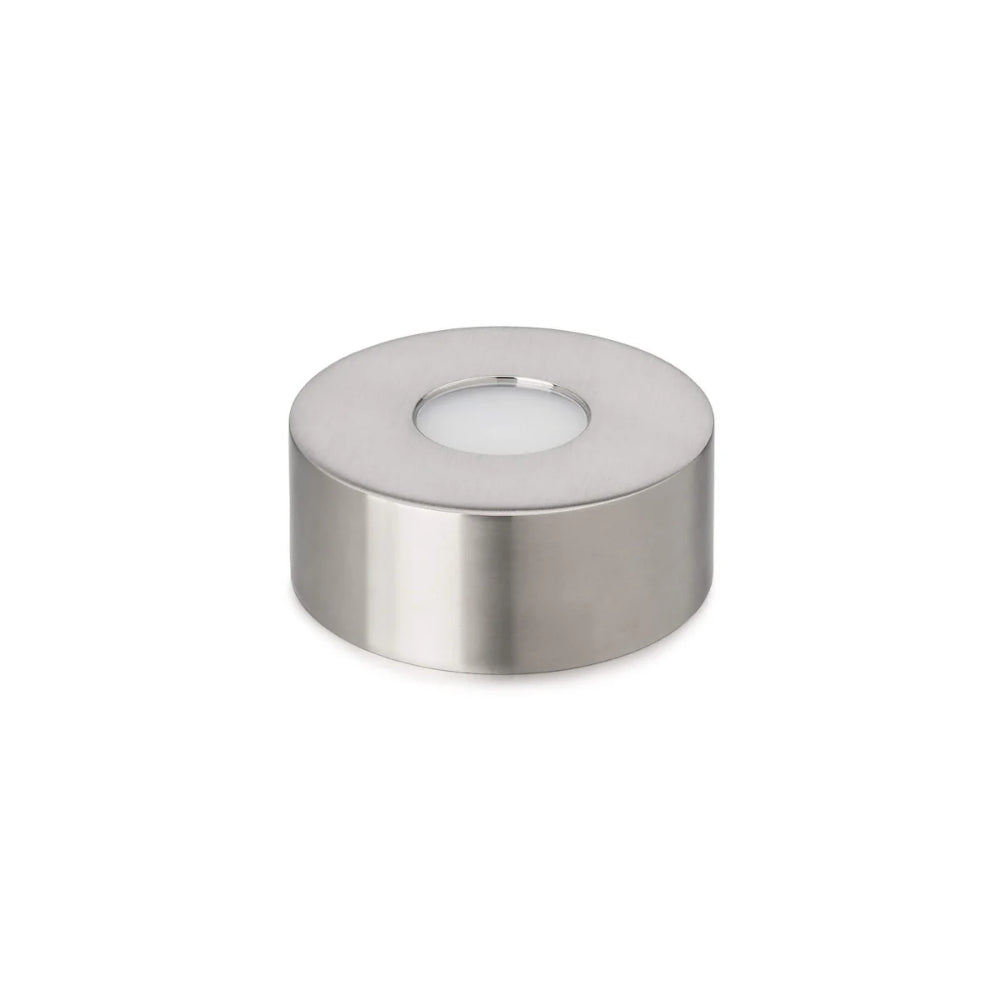 A small  circular LED illumination base with a flat base and a central LED light, in a silver finish.