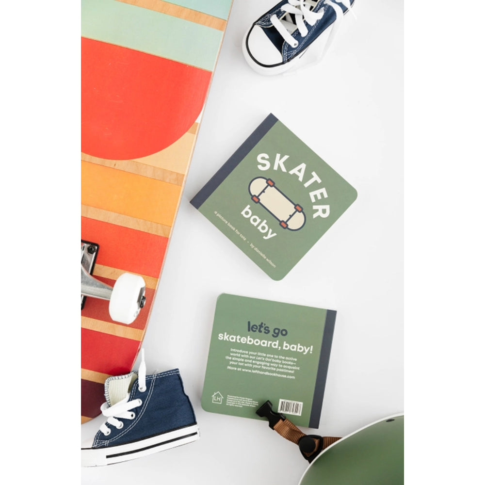 Colorful skateboard, navy sneakers, and baby books on a white surface