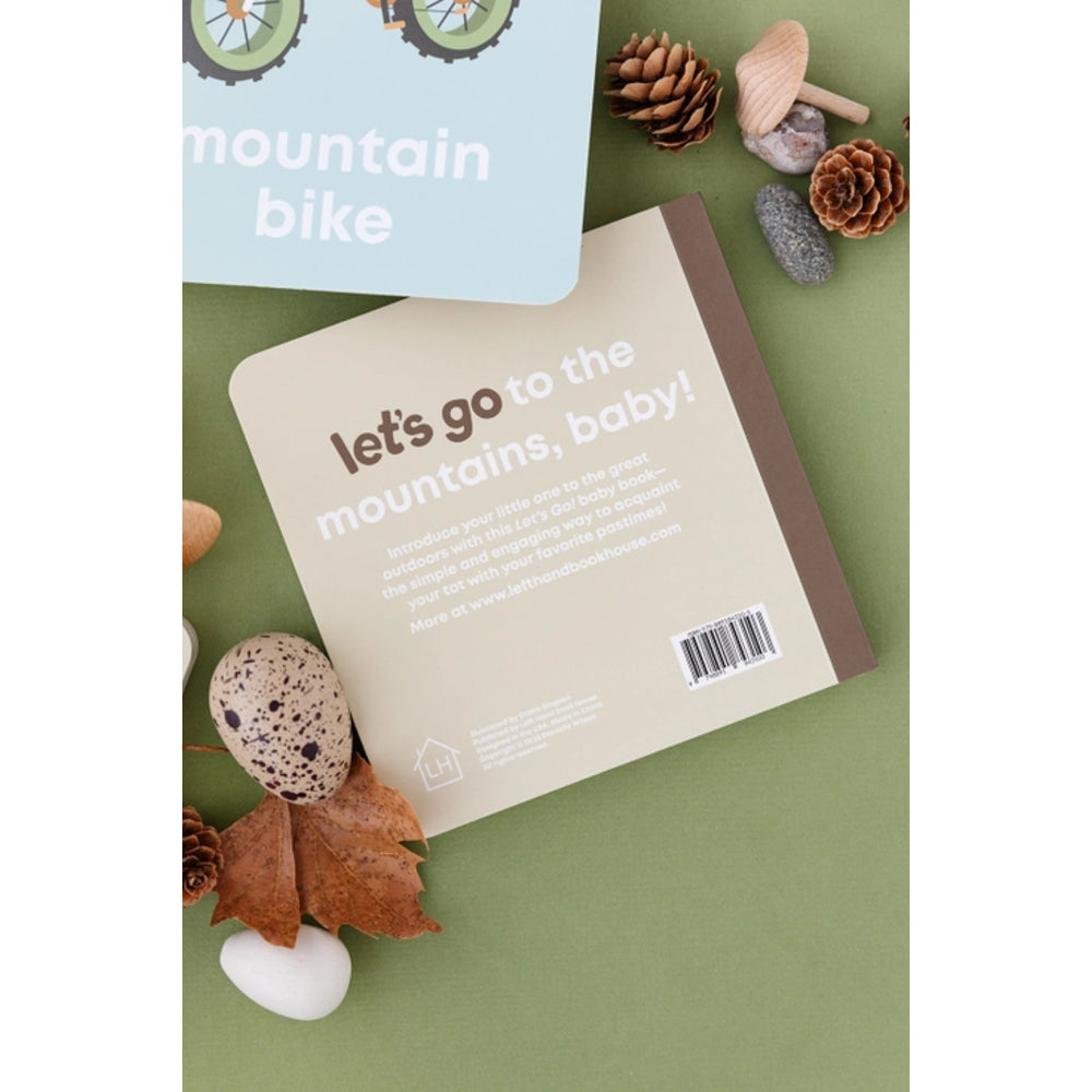 Book with 'let's go to the mountains, baby!' text on a green background with nature-themed decorations.