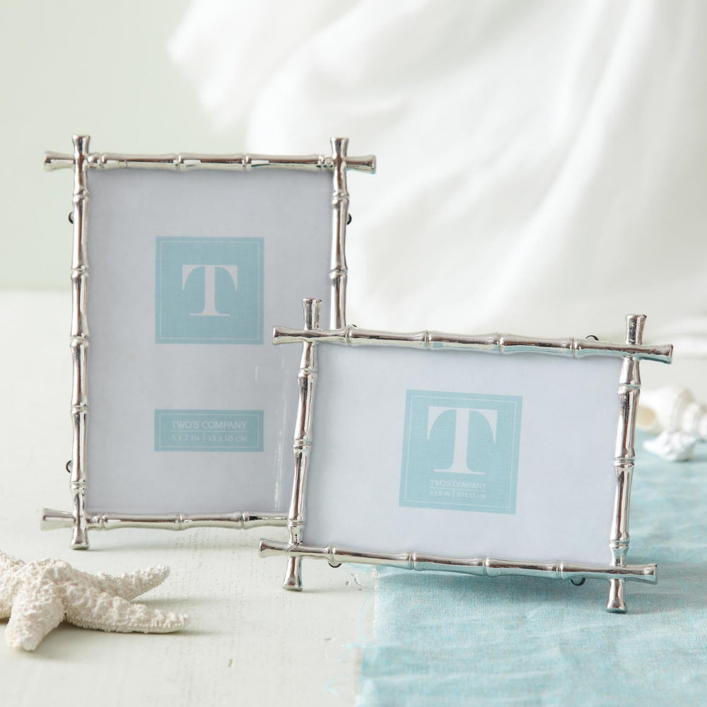 Two silver 4x6 and 5x7 bamboo-style picture frames with a starfish and sea shells on a blue mat on a white backround.