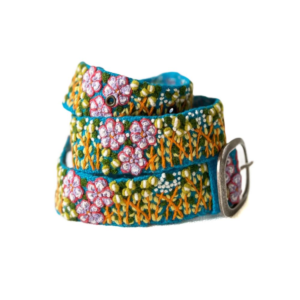 A colorful embroidered wool belt with a metal buckle, featuring a floral pattern on a white background.