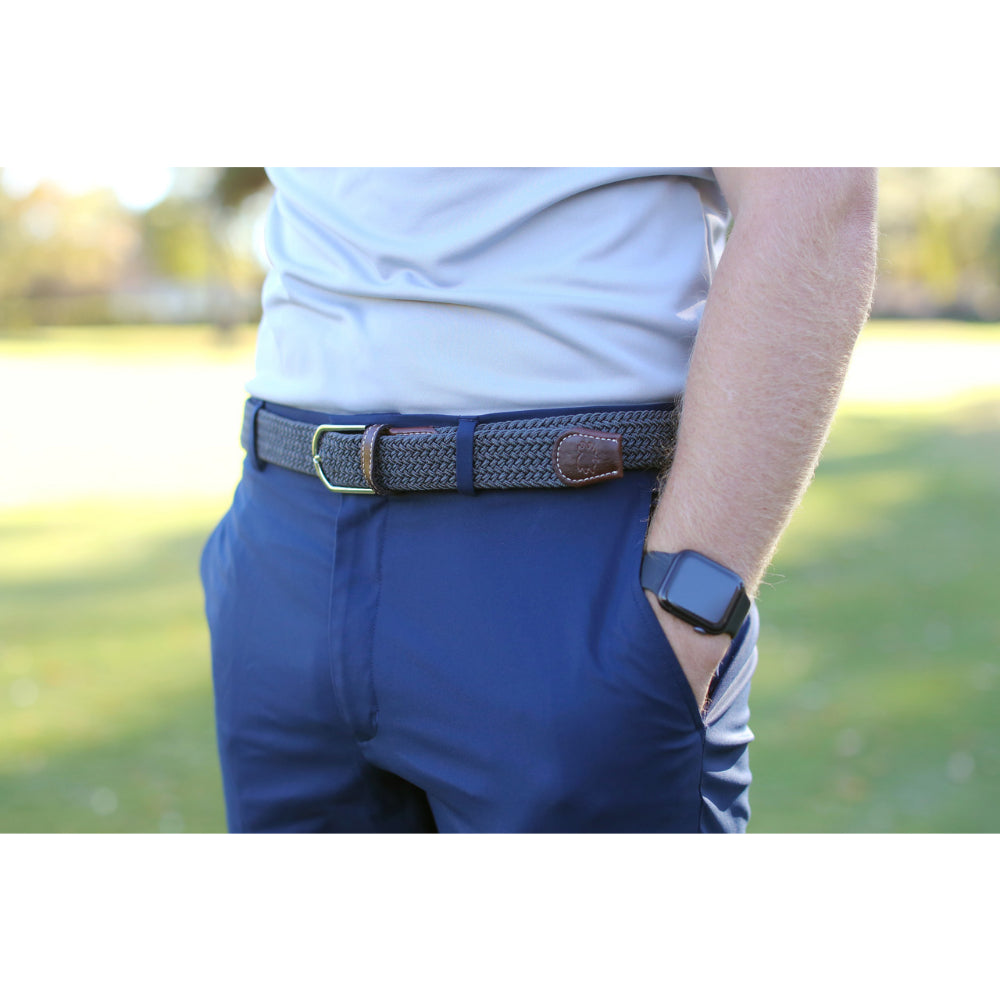 person wearing gray woven belt outdoors. 