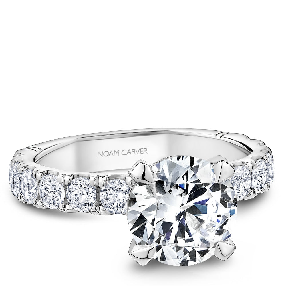 Diamond ring with 'Noam Carver' branding on a white background