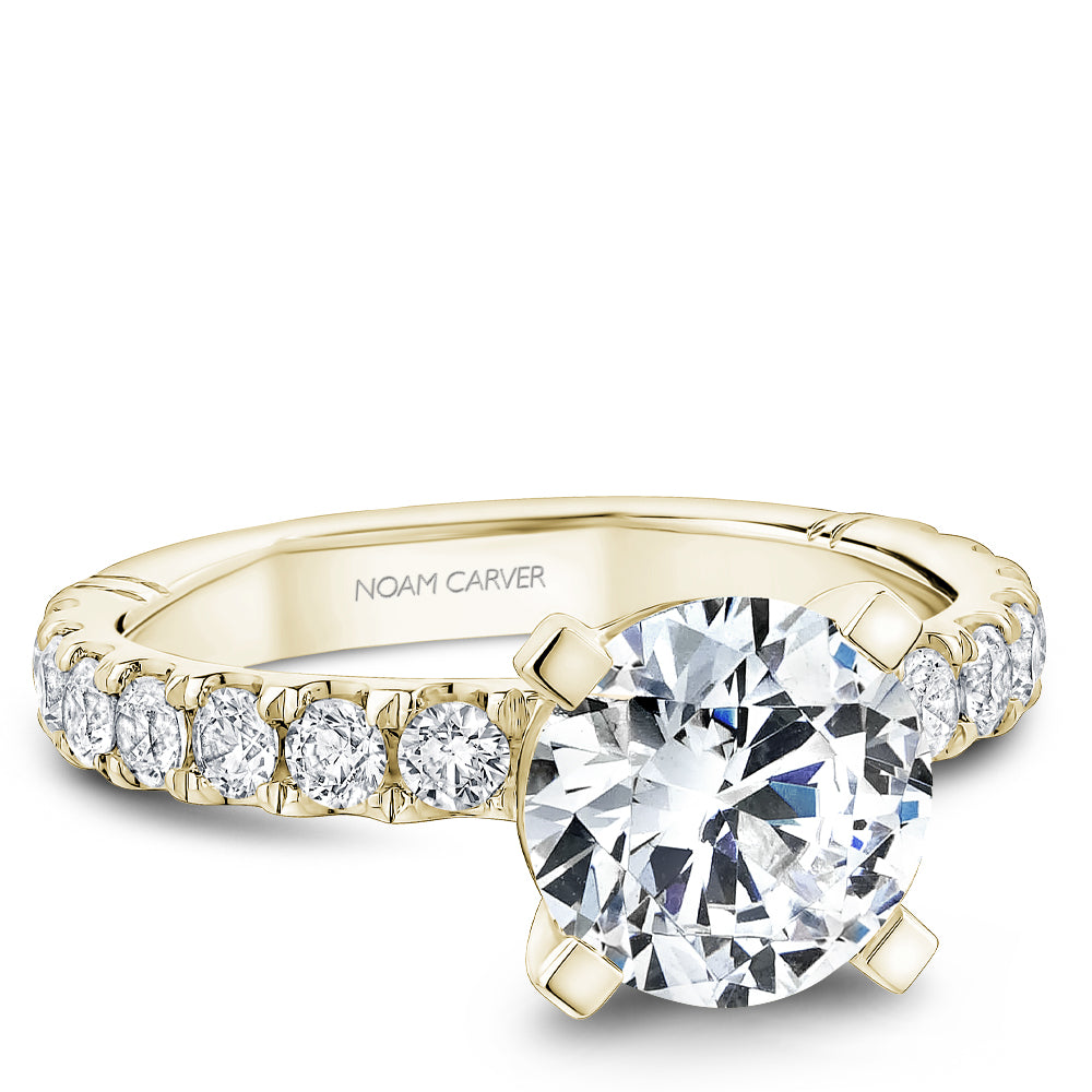 Yellow gold diamond ring with 'Noam Carver' branding on a white background