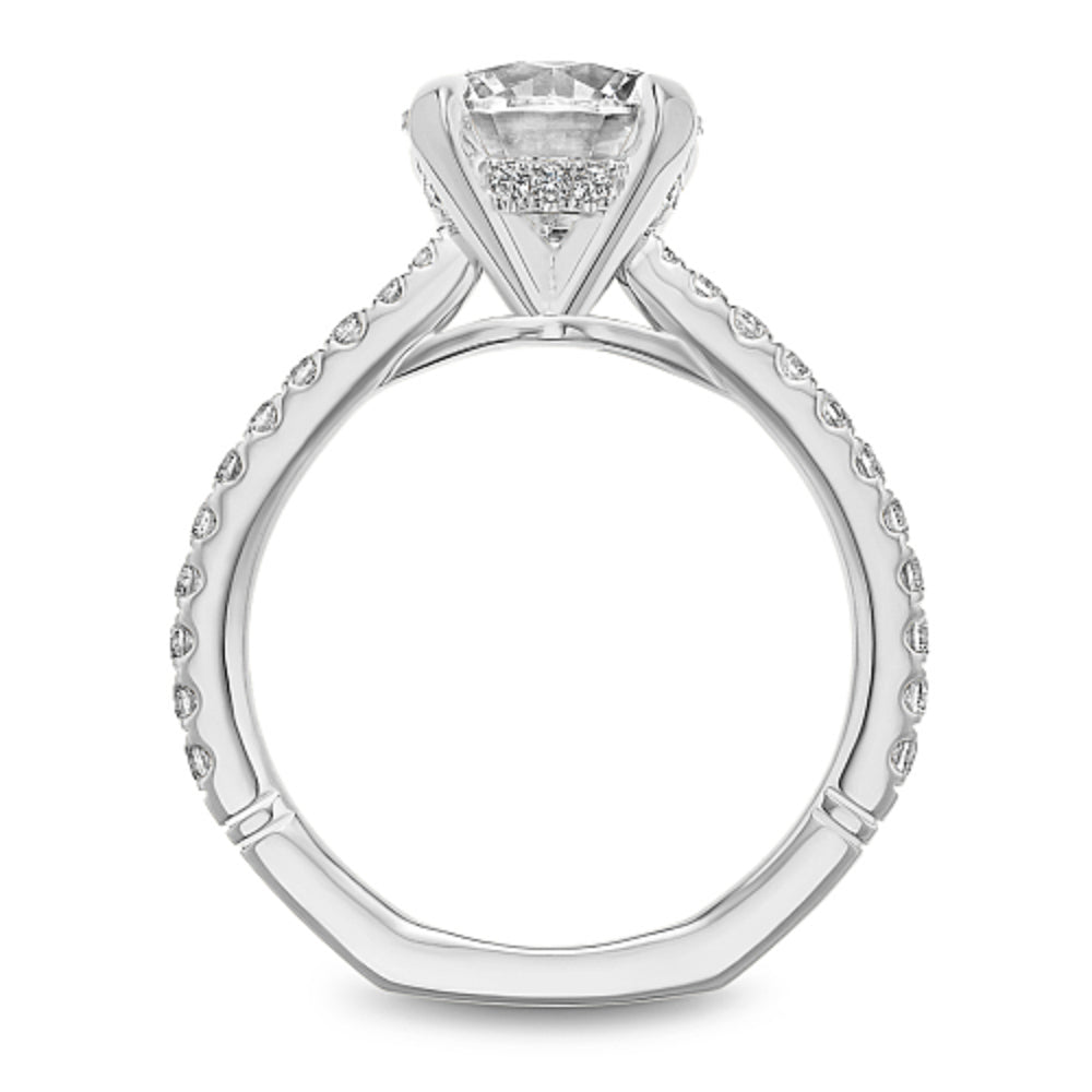 Diamond ring with 'Noam Carver' engraving on a white background