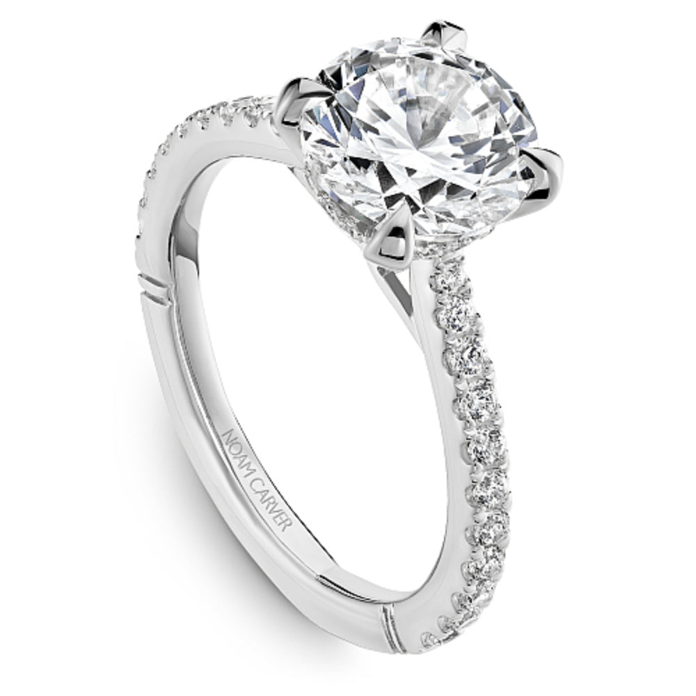 Diamond ring with 'Noam Carver' engraving on a white background