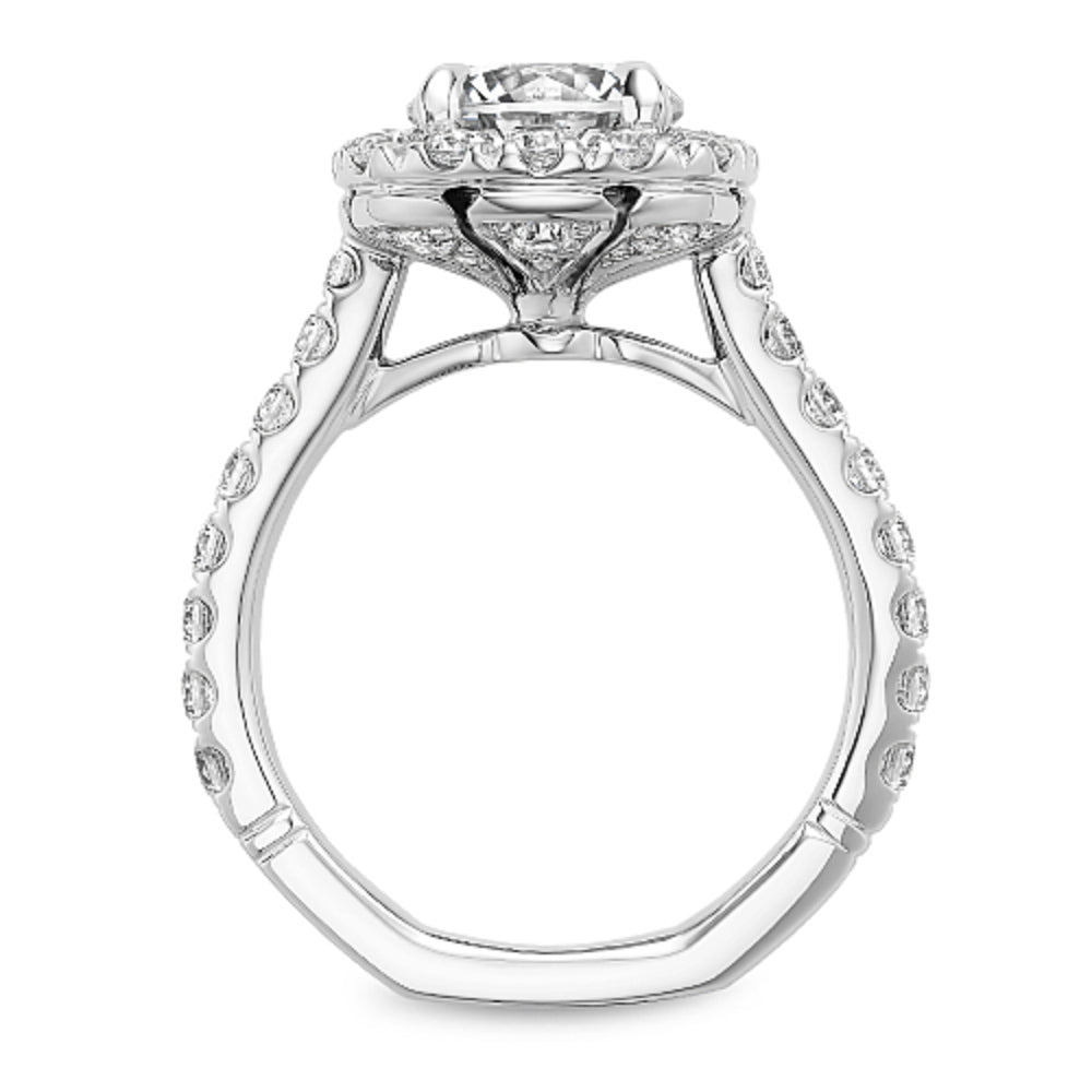Diamond halo ring with 'Noam Carver' branding on a white background