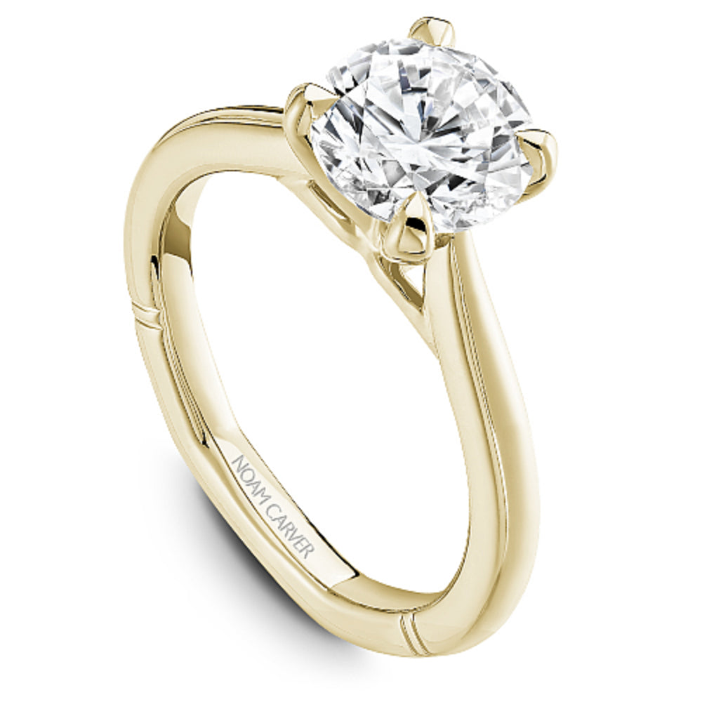 Yellow gold diamond ring with 'Noam Carver' branding on a white background