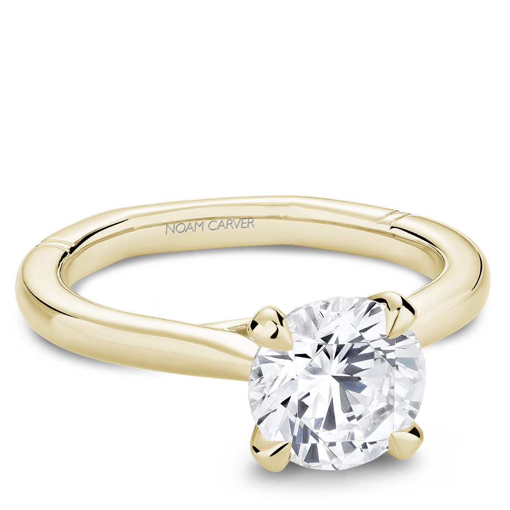 Yellow gold diamond ring with 'Noam Carver' branding on a white background
