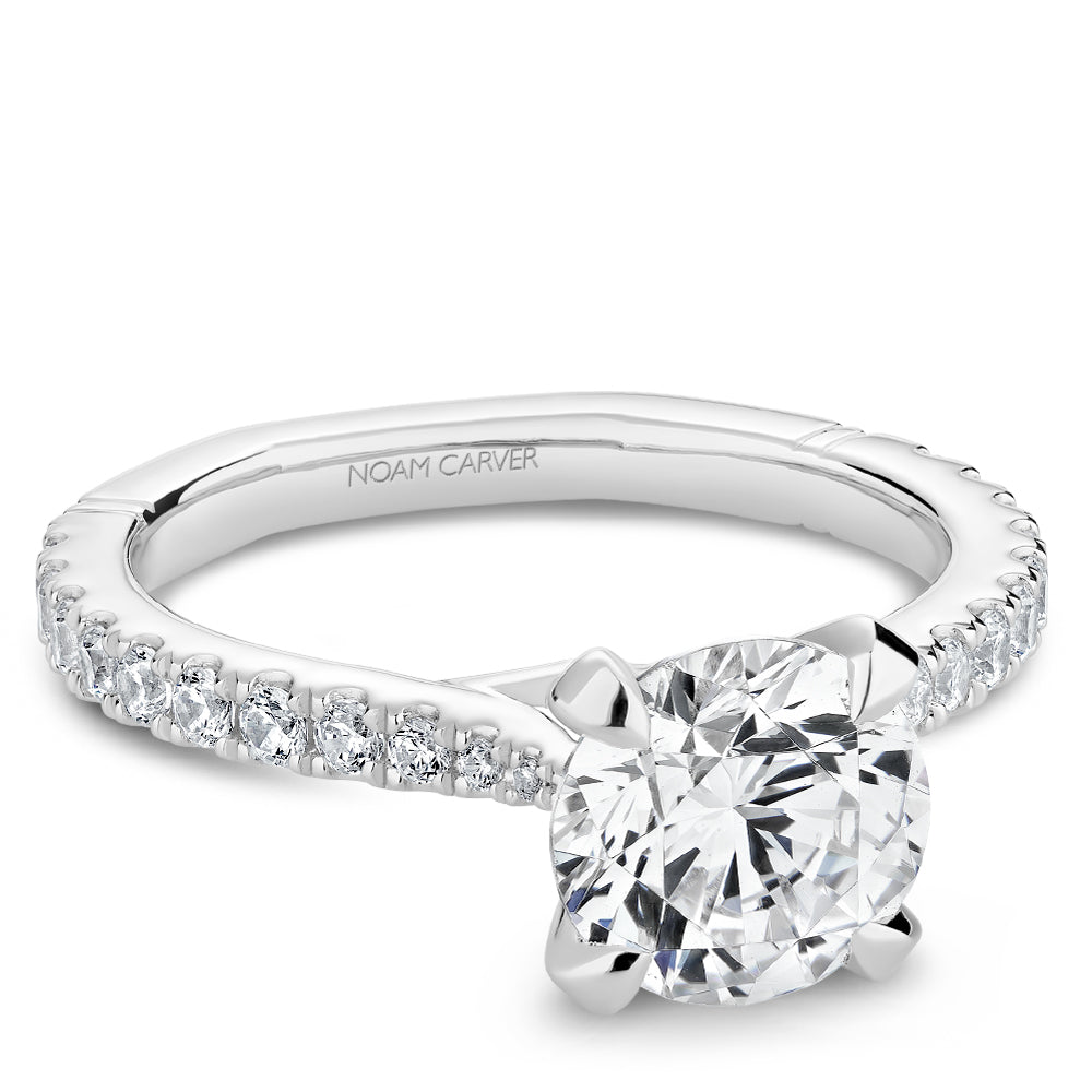 Diamond ring with 'Noam Carver' branding on a white background