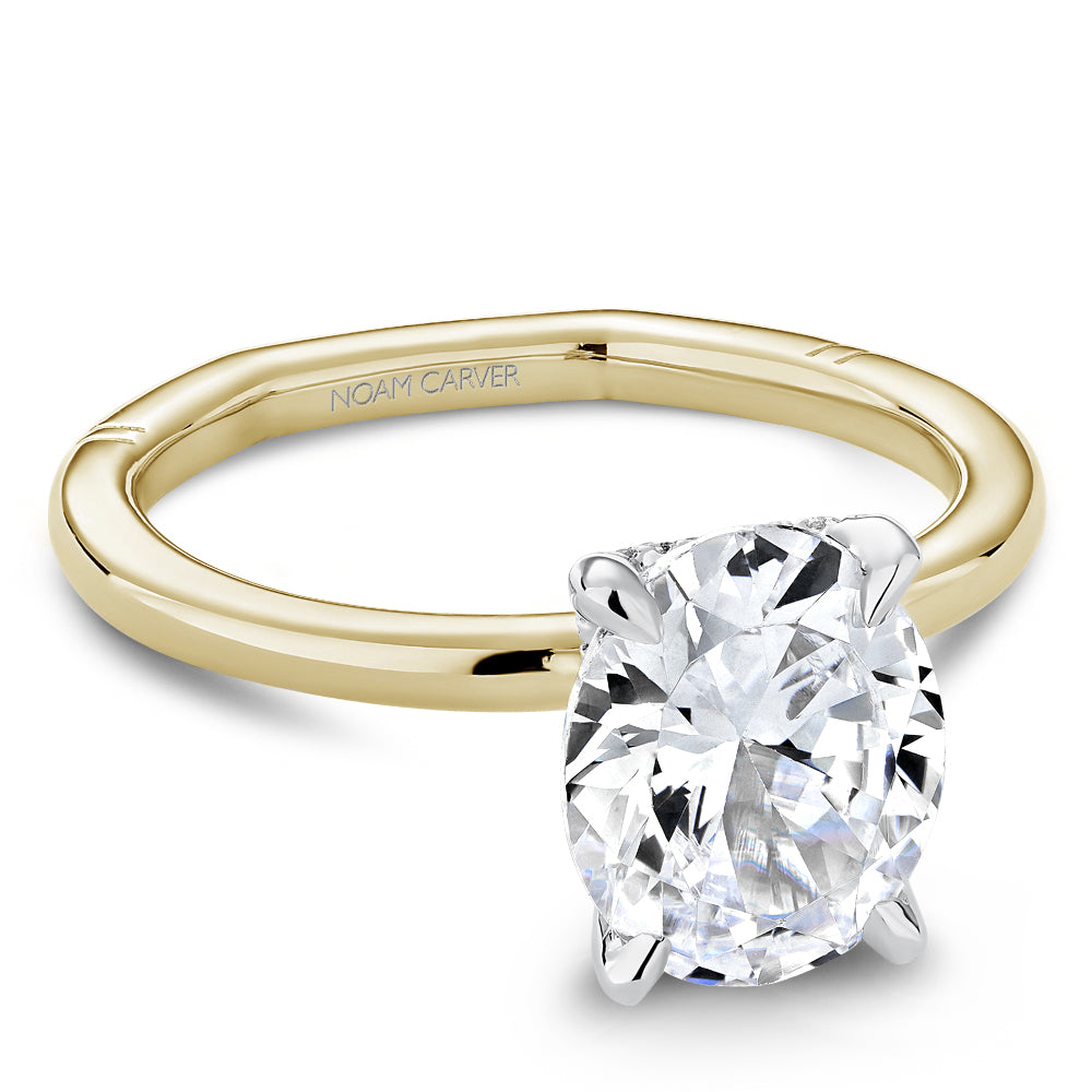 Gold Noam Carver euroshank ring with an oval diamond center on a white background