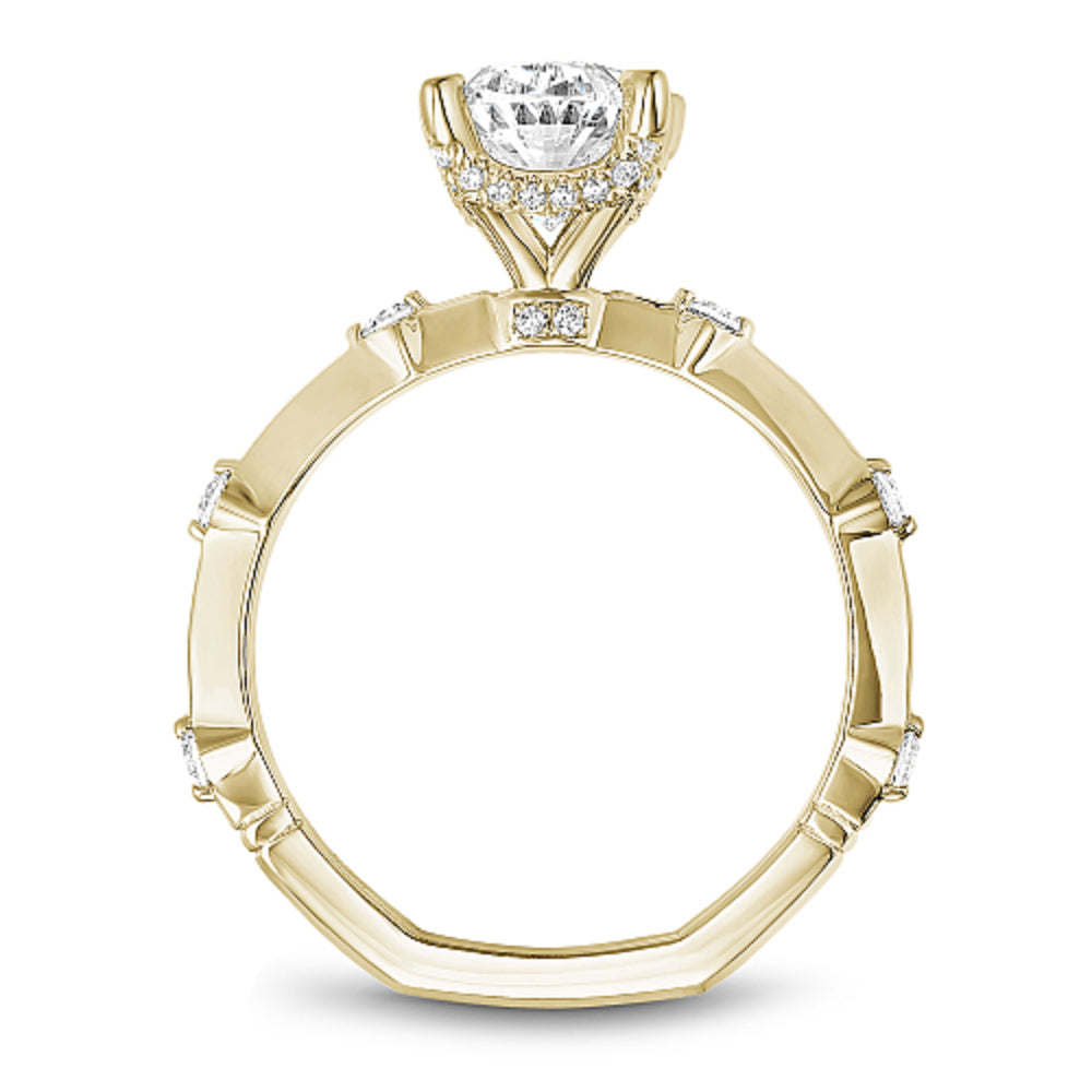 Gold Noam Carver ring with an oval diamond center and round diamond shank accents on a white background