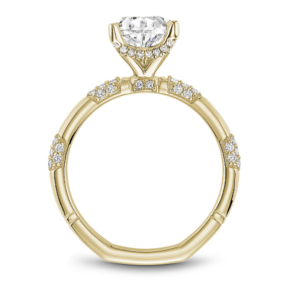 Gold Noam Carver ring with a pear-shaped diamond and pave diamond station sides on a white background