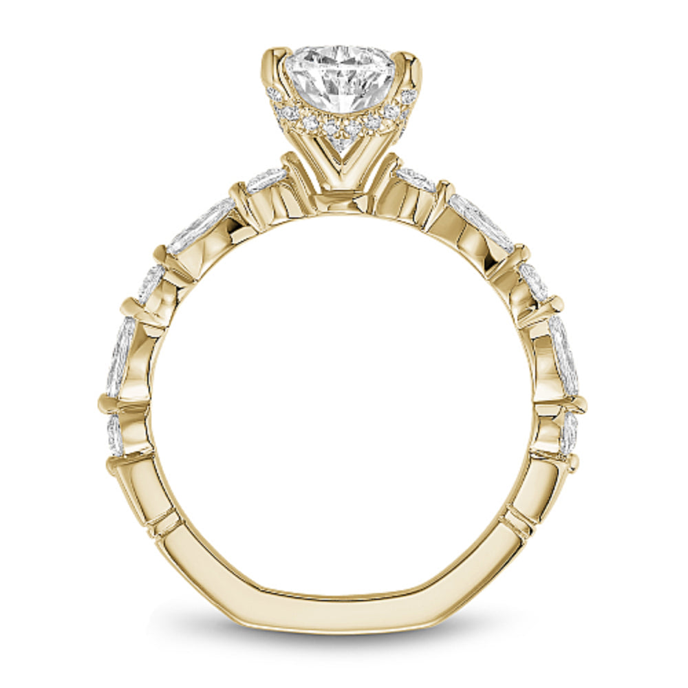 Gold diamond ring with 'Noam Carver' branding on a white background