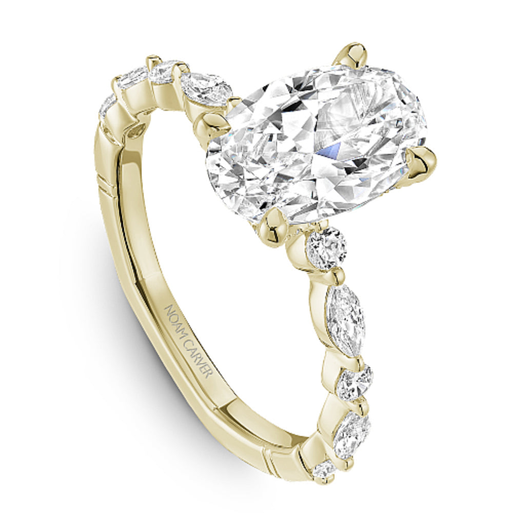 Gold diamond ring with 'Noam Carver' branding on a white background