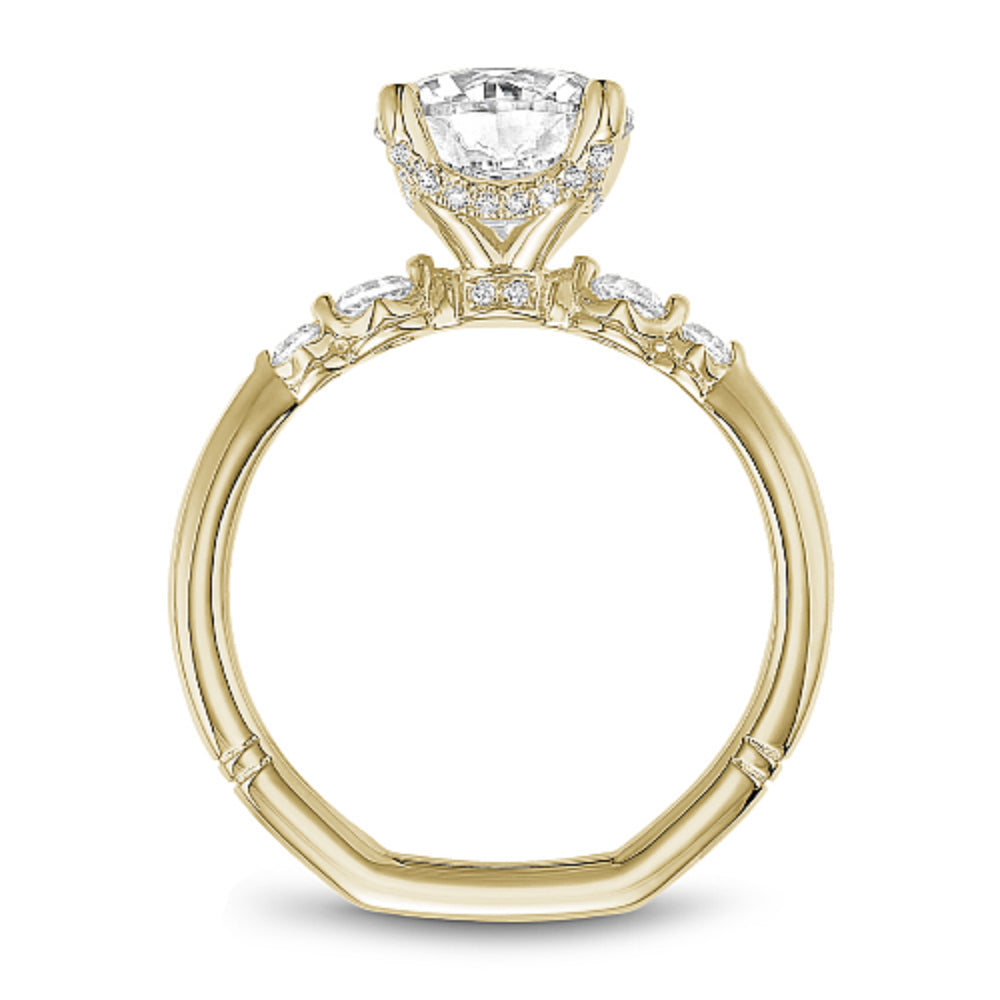 Gold Noam Carver ring with a large round diamond and smaller diamonds on the band against a white background