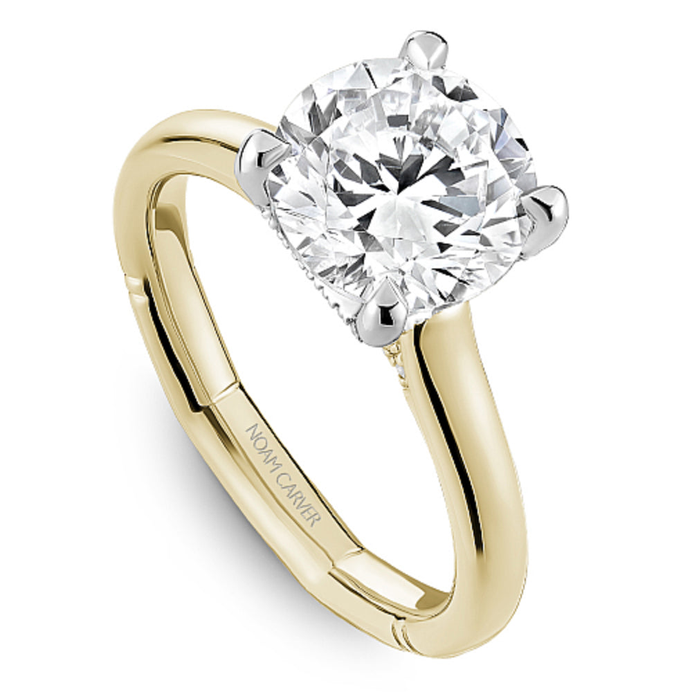 Diamond ring with 'Noam Carver' branding on a white background