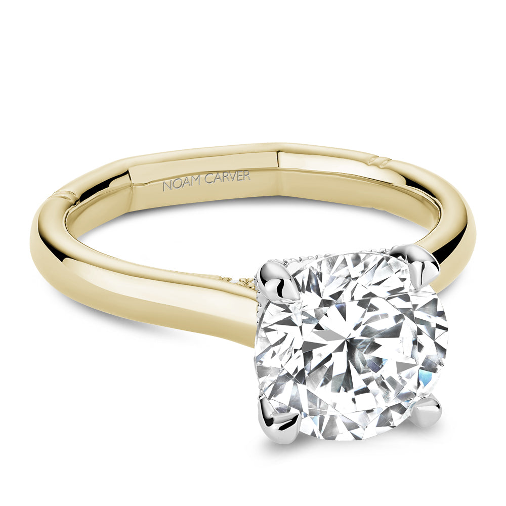 Diamond ring with 'Noam Carver' branding on a white background