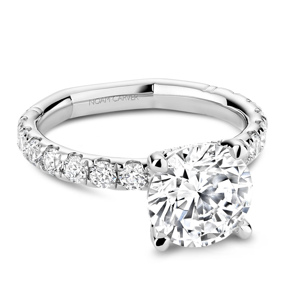 Diamond ring with 'Noam Carver' branding on a white background
