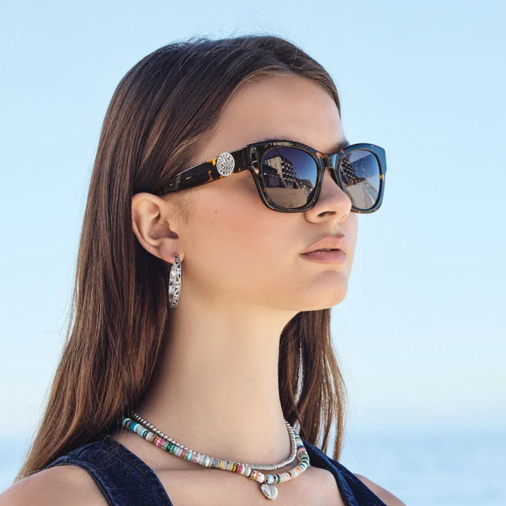 Woman wearing sunglasses with a blue sky background
